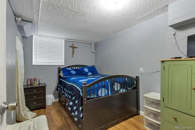 a bedroom with a bed and a refrigerator