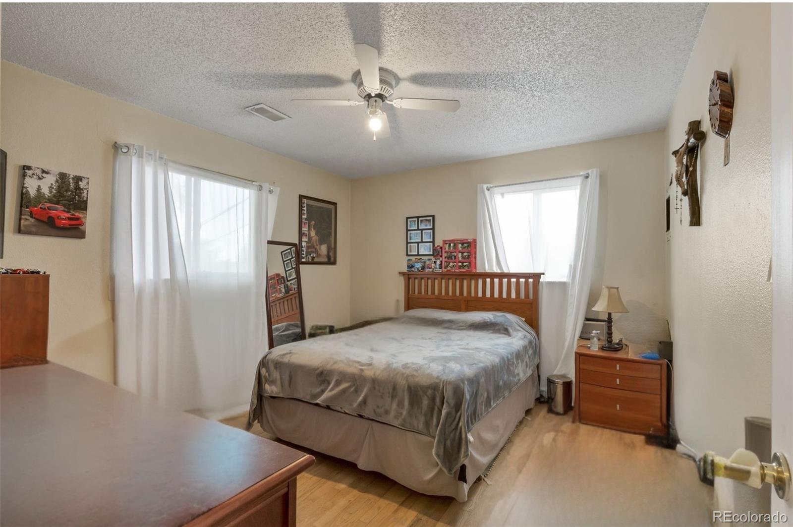 326 South Alcott Street Denver, CO 80219 - Photo 17 of 21 a bedroom with a bed and a refrigerator