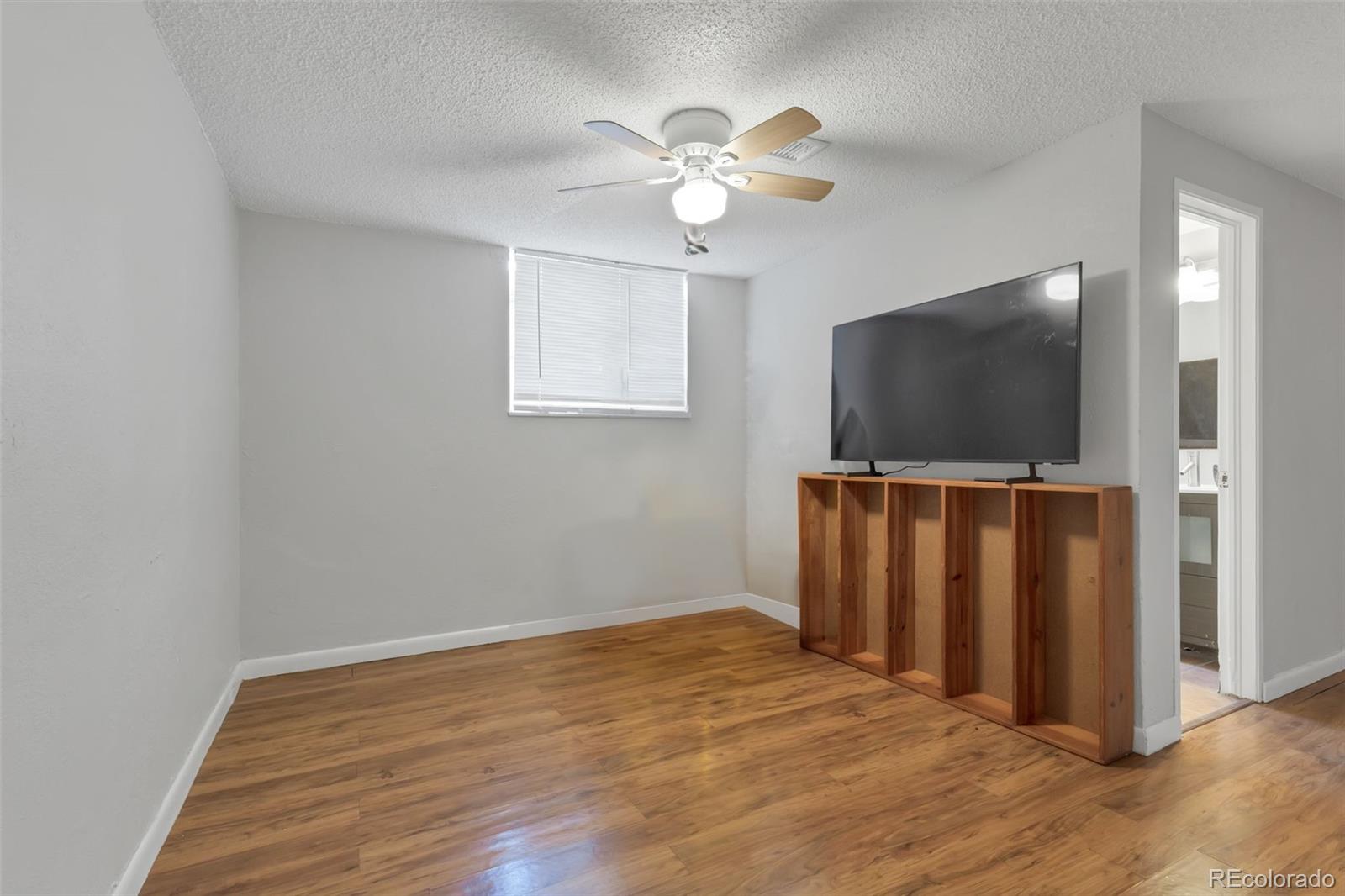 326 South Alcott Street Denver, CO 80219 - Photo 18 of 21 a view of a livingroom with wooden floor and a flat screen tv