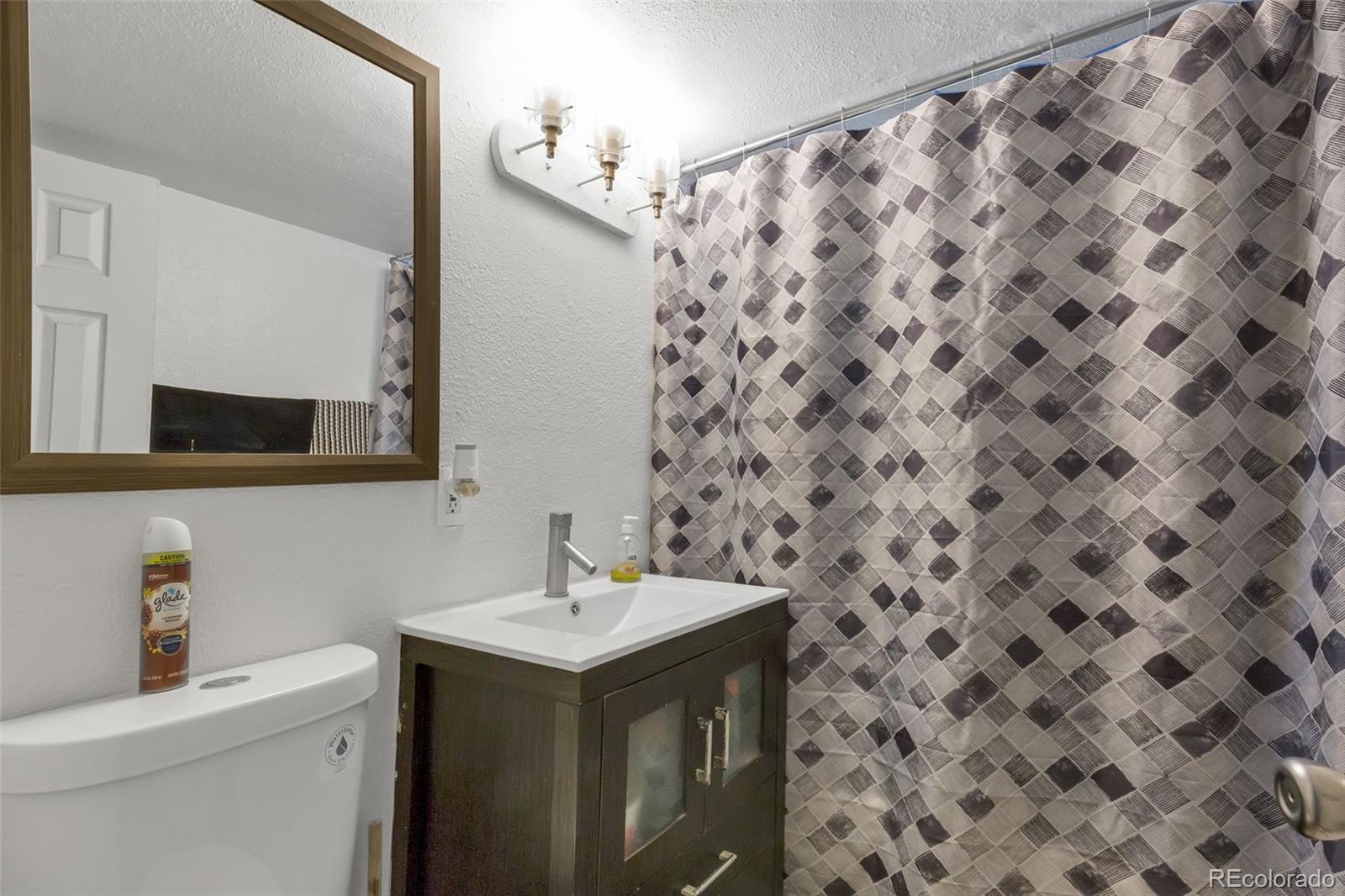 326 South Alcott Street Denver, CO 80219 - Photo 19 of 21 a bathroom with a sink and a mirror