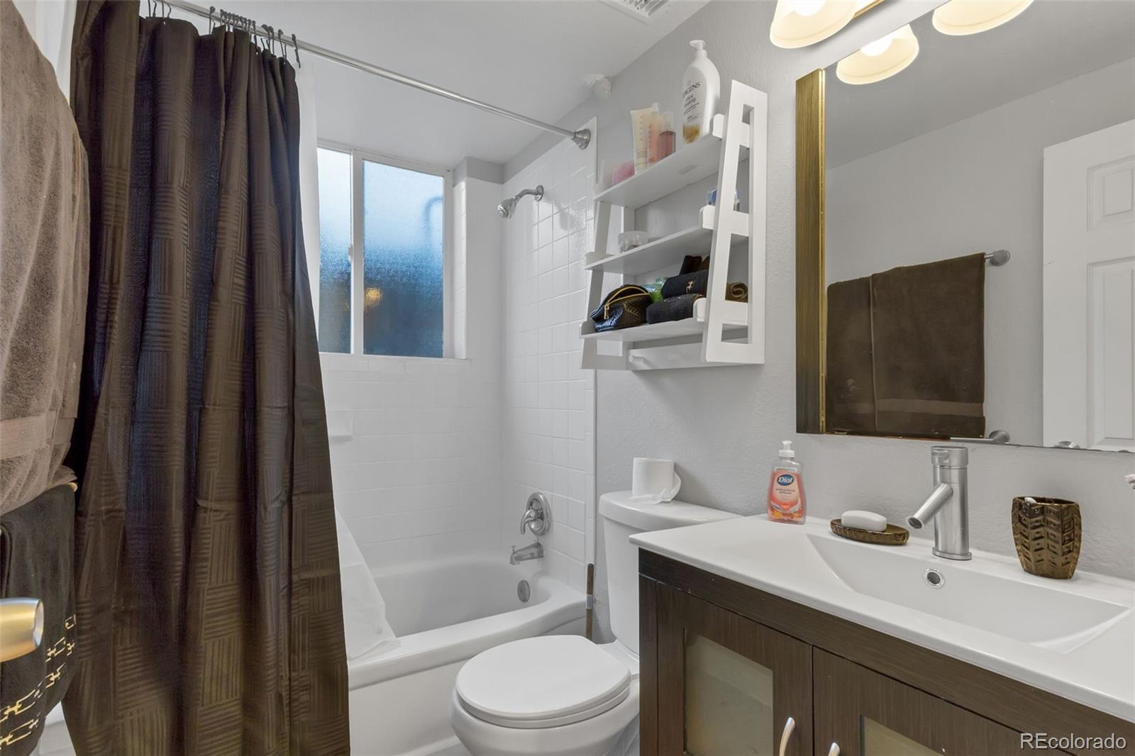 326 South Alcott Street Denver, CO 80219 - Photo 20 of 21 a bathroom with a granite countertop sink toilet and shower