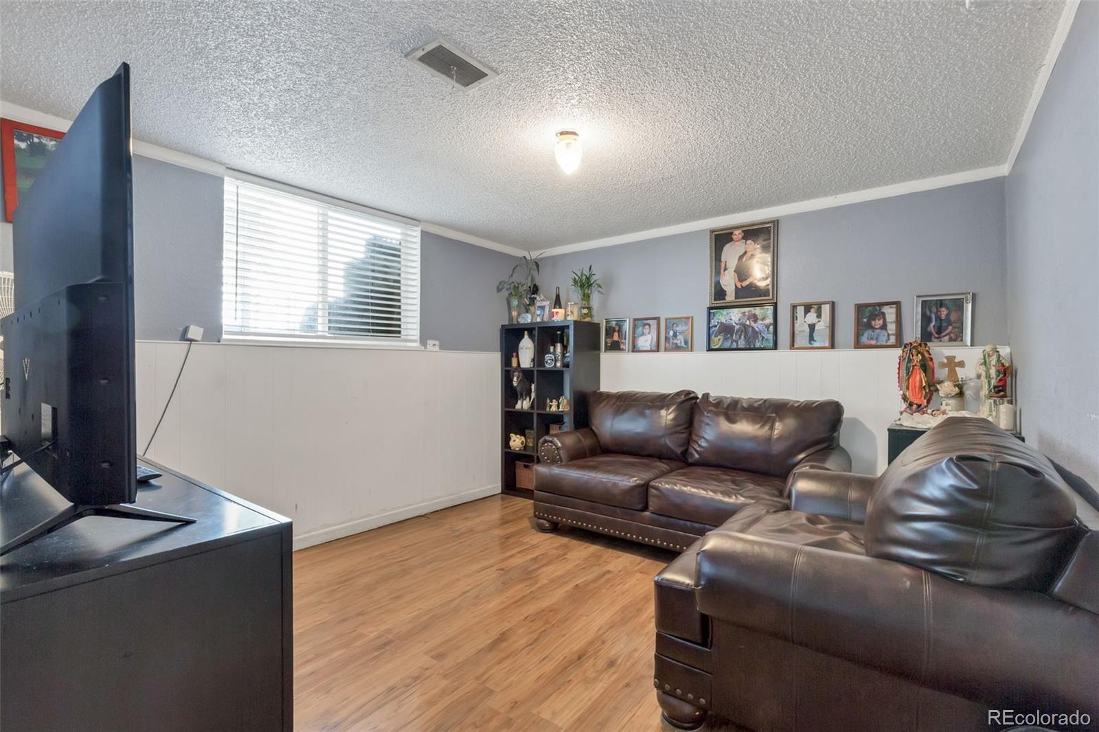326 South Alcott Street Denver, CO 80219 - Photo 7 of 21 a living room with furniture and a flat screen tv