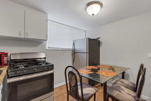 a kitchen with a refrigerator and a stove top oven