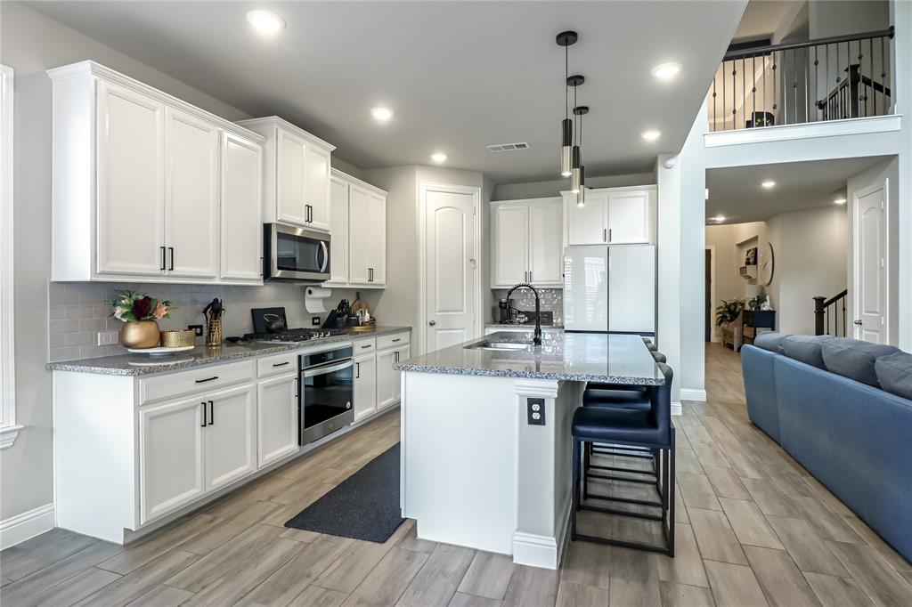 2400 Mill Pl Road Mansfield, TX 76063 - Photo 13 of 32 a kitchen with stainless steel appliances a stove top oven a sink dishwasher and a refrigerator