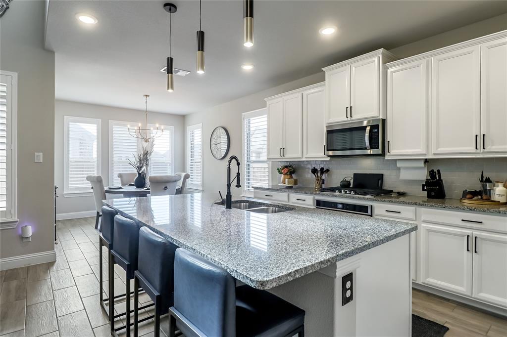 2400 Mill Pl Road Mansfield, TX 76063 - Photo 14 of 32 a kitchen with stainless steel appliances granite countertop a sink a stove and cabinets