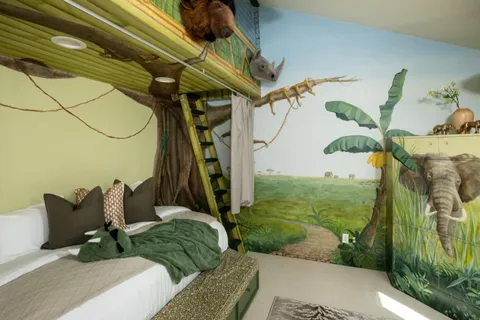 a bedroom with a bed and a large window