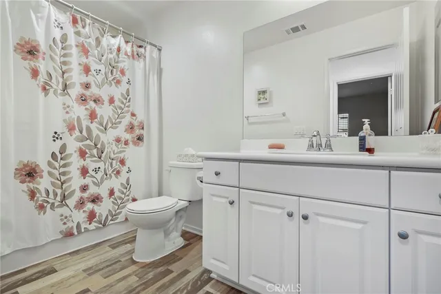 a bedroom with a bed and a dresser in it