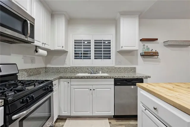 a kitchen with granite countertop a stove and a sink