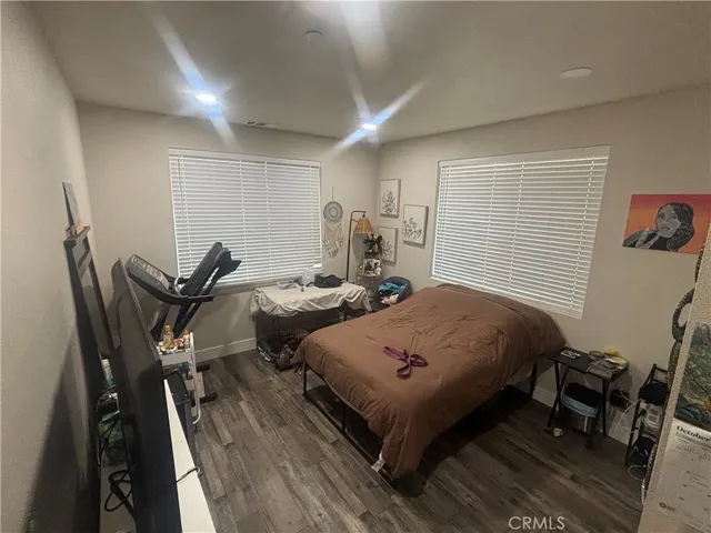 a bed room with two bed and a chair