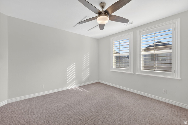 14738 Tangle Hill Road Herriman, UT 84096 - Photo 37 of 66 Room featuring dual windows with white plantation shutters, neutral tone carpeting, and a ceiling fan with integrated lighting