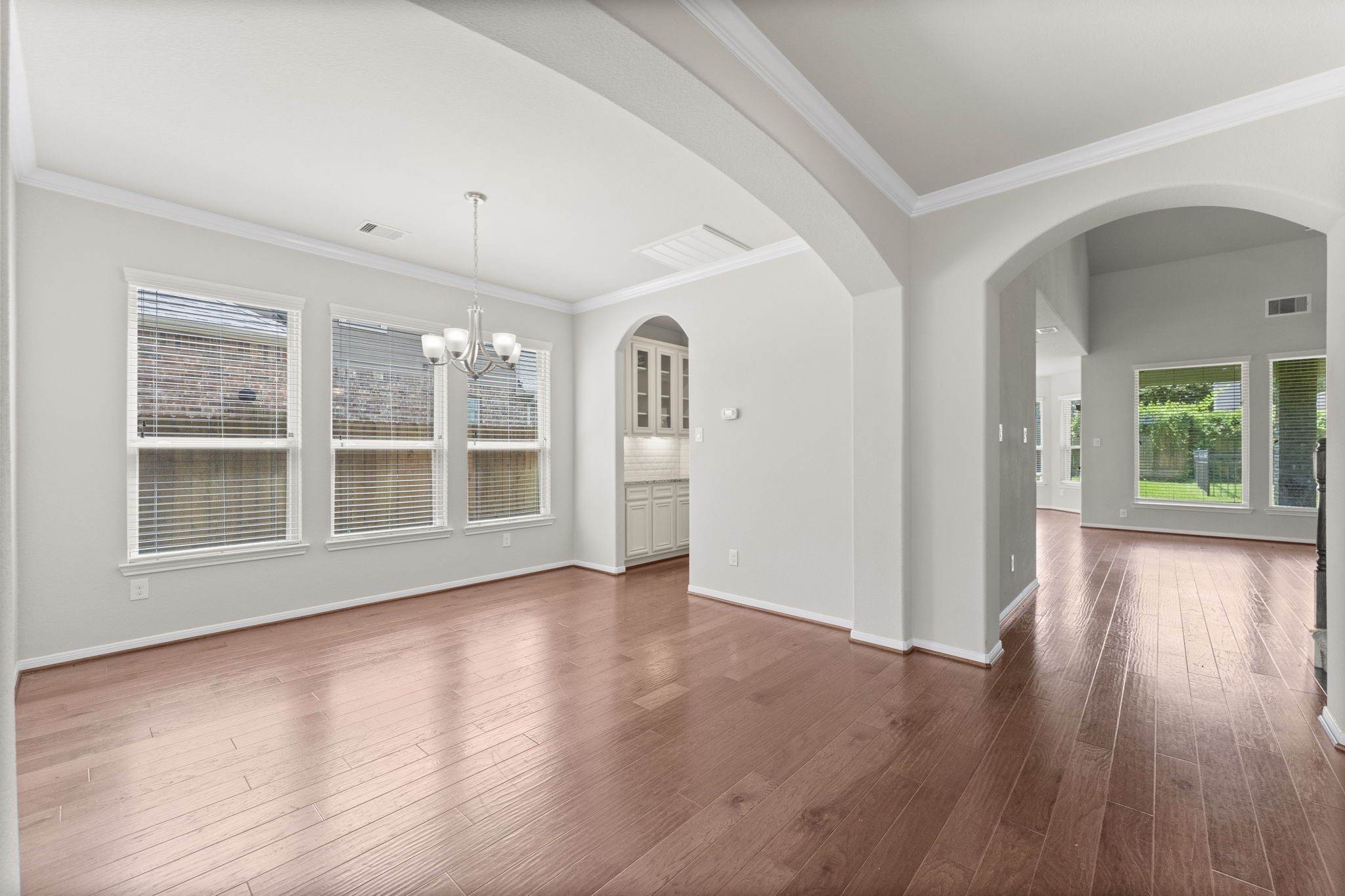 5015 Gold Lantana Trail Spring, TX 77389 - Photo 12 of 50 a view of an empty room with wooden floor and a window