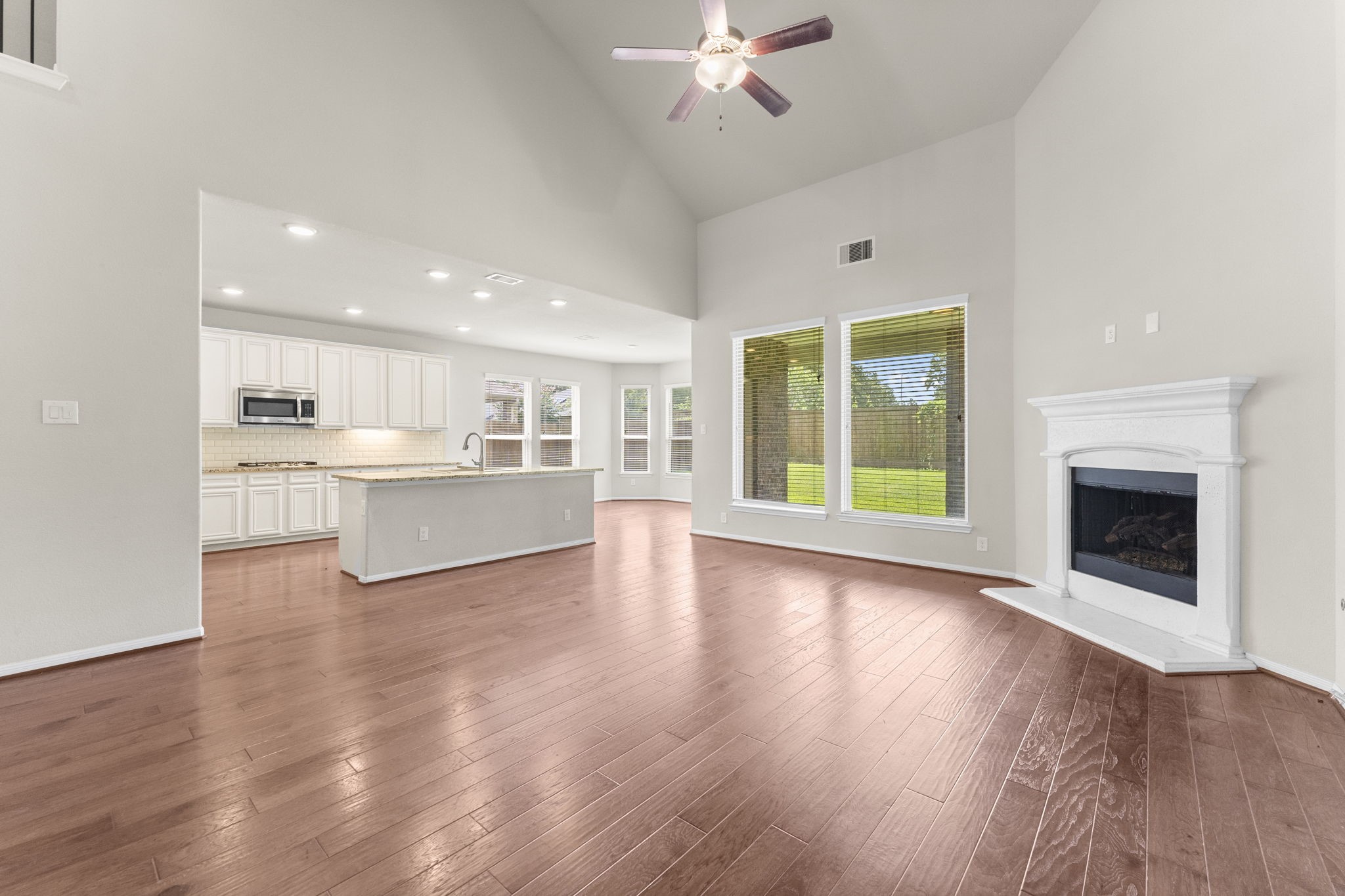 5015 Gold Lantana Trail Spring, TX 77389 - Photo 16 of 50 a view of an empty room with a kitchen and a fireplace