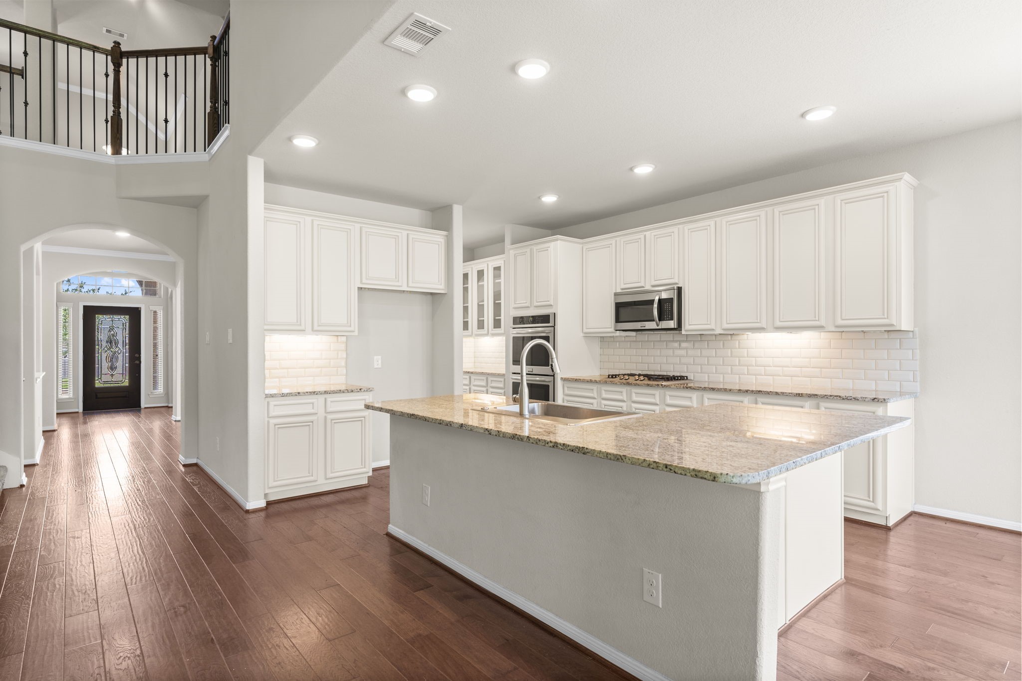 5015 Gold Lantana Trail Spring, TX 77389 - Photo 18 of 50 a kitchen with stainless steel appliances granite countertop a lot of counter space and wooden floors