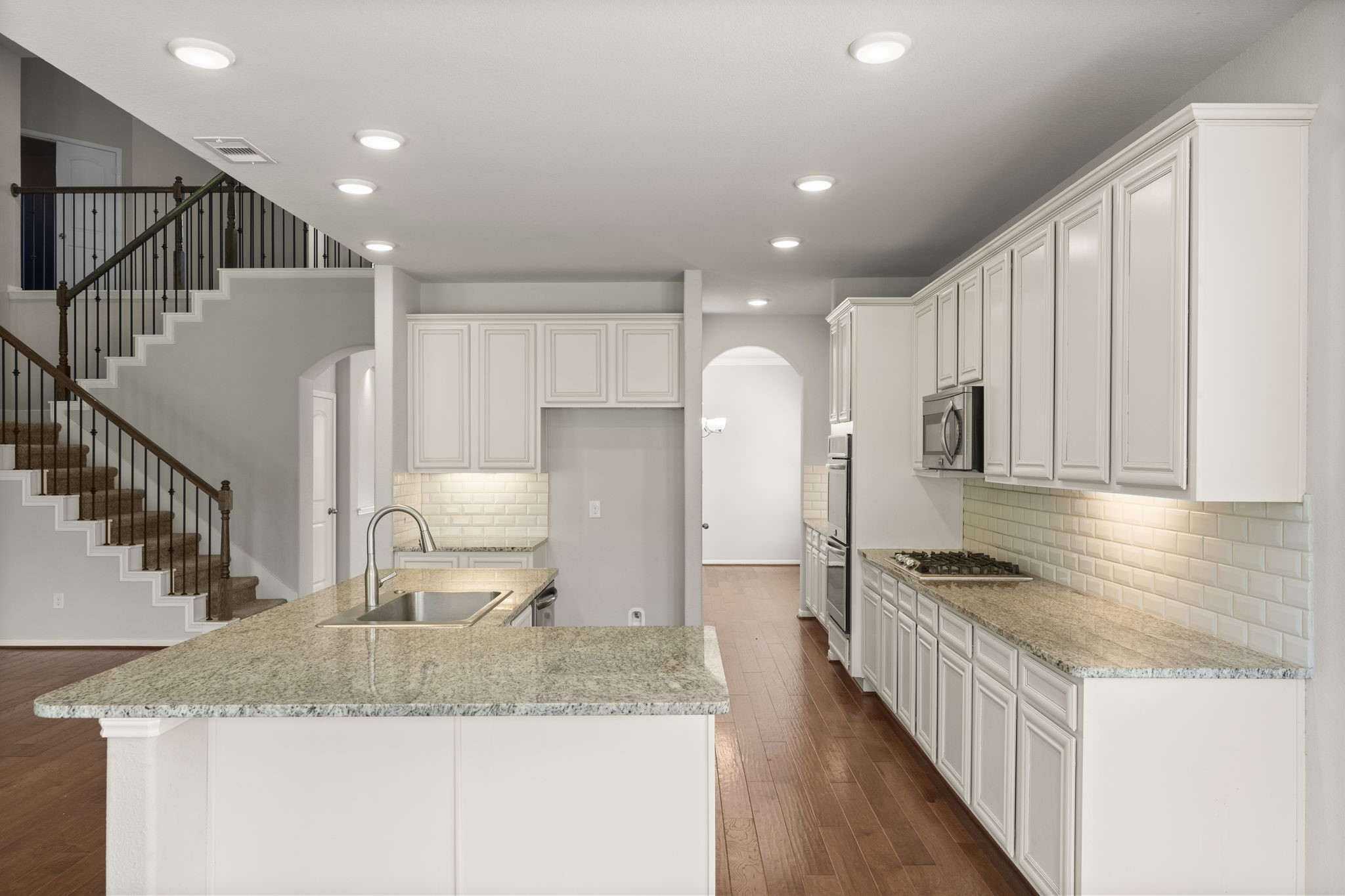 5015 Gold Lantana Trail Spring, TX 77389 - Photo 19 of 50 a kitchen with stainless steel appliances granite countertop a sink refrigerator and cabinets