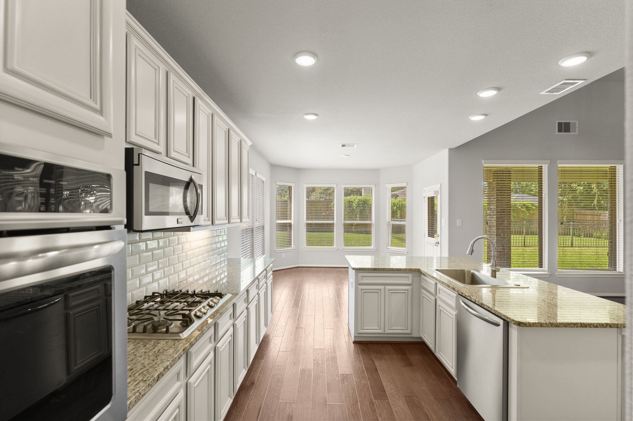 5015 Gold Lantana Trail Spring, TX 77389 - Photo 20 of 50 a kitchen with stainless steel appliances kitchen island granite countertop a stove a sink and a refrigerator