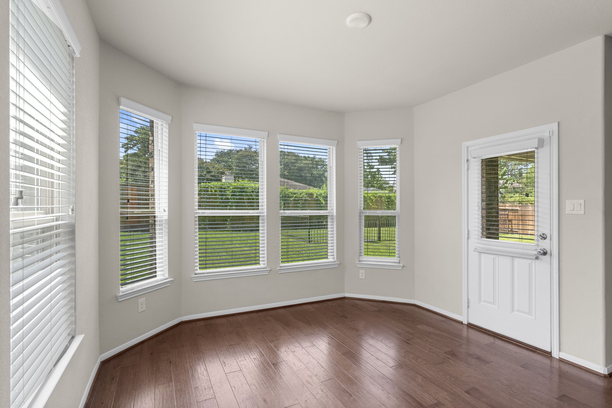 5015 Gold Lantana Trail Spring, TX 77389 - Photo 22 of 50 a view of an empty room with wooden floor and windows