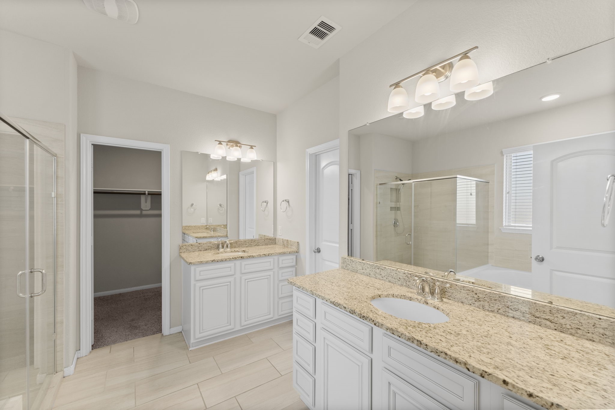 5015 Gold Lantana Trail Spring, TX 77389 - Photo 27 of 50 a bathroom with a granite countertop sink a large mirror and a shower