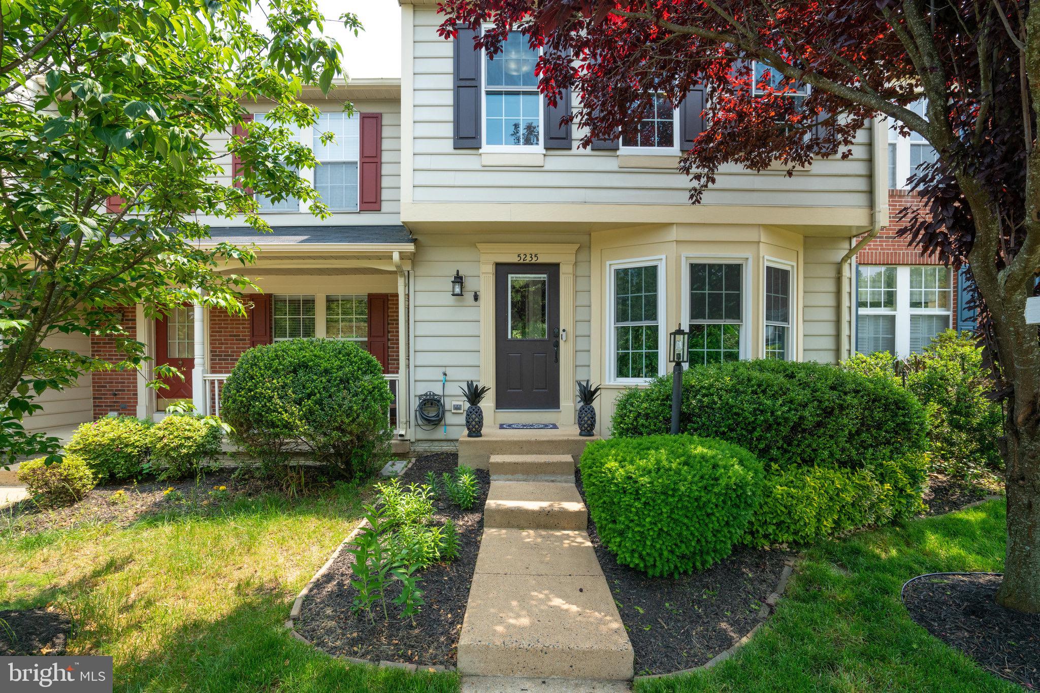 front view of a brick house with a yard