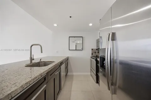 a kitchen with granite countertop stainless steel appliances and a counter top