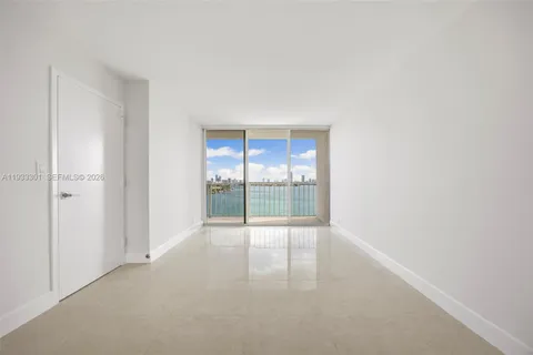 a view of an empty room with glass door