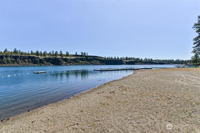 33816 Aztec Lane Cheney, WA 99004 - Photo 16 of 24 a view of a lake with houses in the back