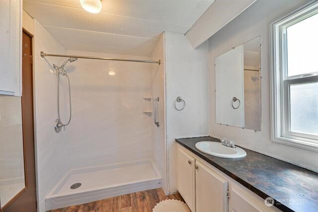 33816 Aztec Lane Cheney, WA 99004 - Photo 8 of 24 a bathroom with a granite countertop sink a mirror and a shower