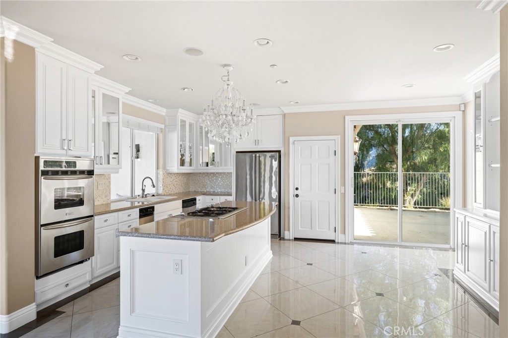 7370 West Chantilly Court Tujunga, CA 91042 - Photo 12 of 55 a kitchen that has a lot of cabinets and refrigerator