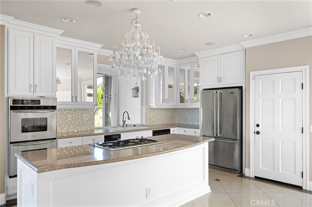 7370 West Chantilly Court Tujunga, CA 91042 - Photo 14 of 55 a kitchen with stainless steel appliances granite countertop a sink refrigerator and cabinets