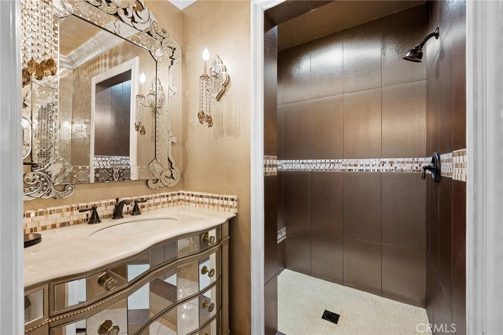 7370 West Chantilly Court Tujunga, CA 91042 - Photo 19 of 55 a bathroom with a sink mirror and shower