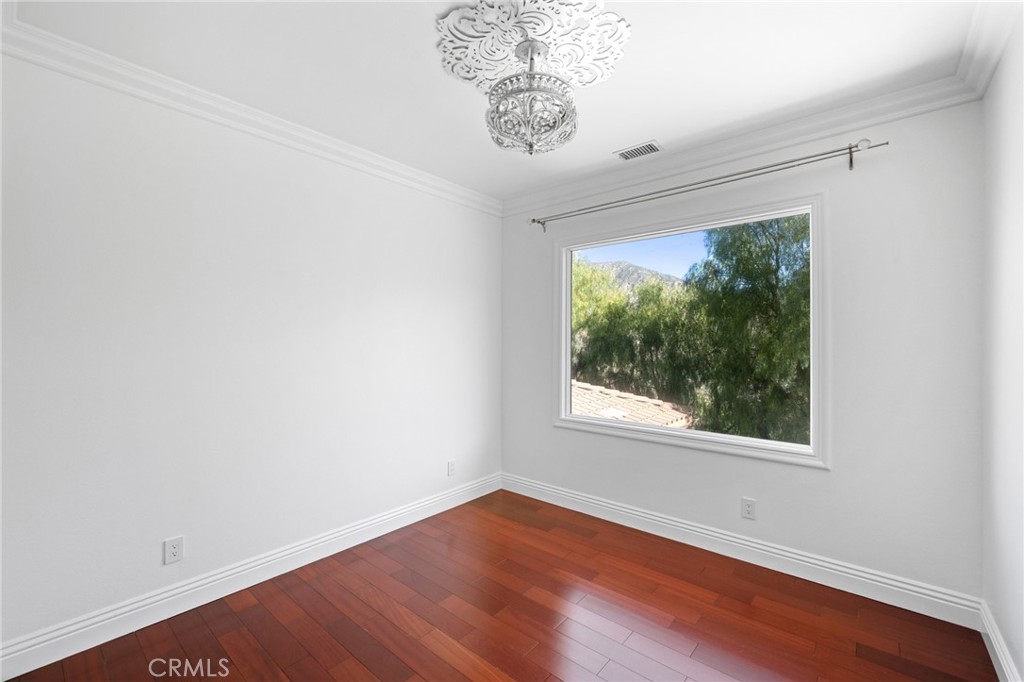7370 West Chantilly Court Tujunga, CA 91042 - Photo 38 of 55 an empty room with wooden floor and windows