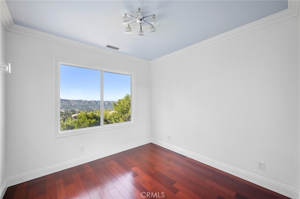 7370 West Chantilly Court Tujunga, CA 91042 - Photo 40 of 55 an empty room with wooden floor chandelier and windows