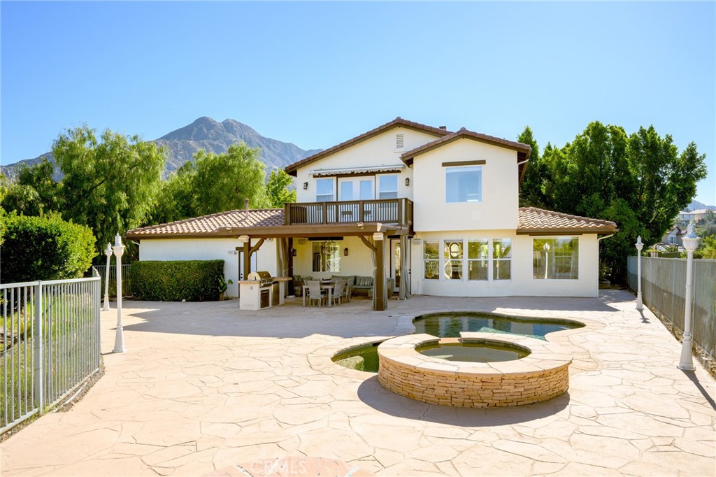 7370 West Chantilly Court Tujunga, CA 91042 - Photo 43 of 55 a front view of a house with a yard garage and a fountain