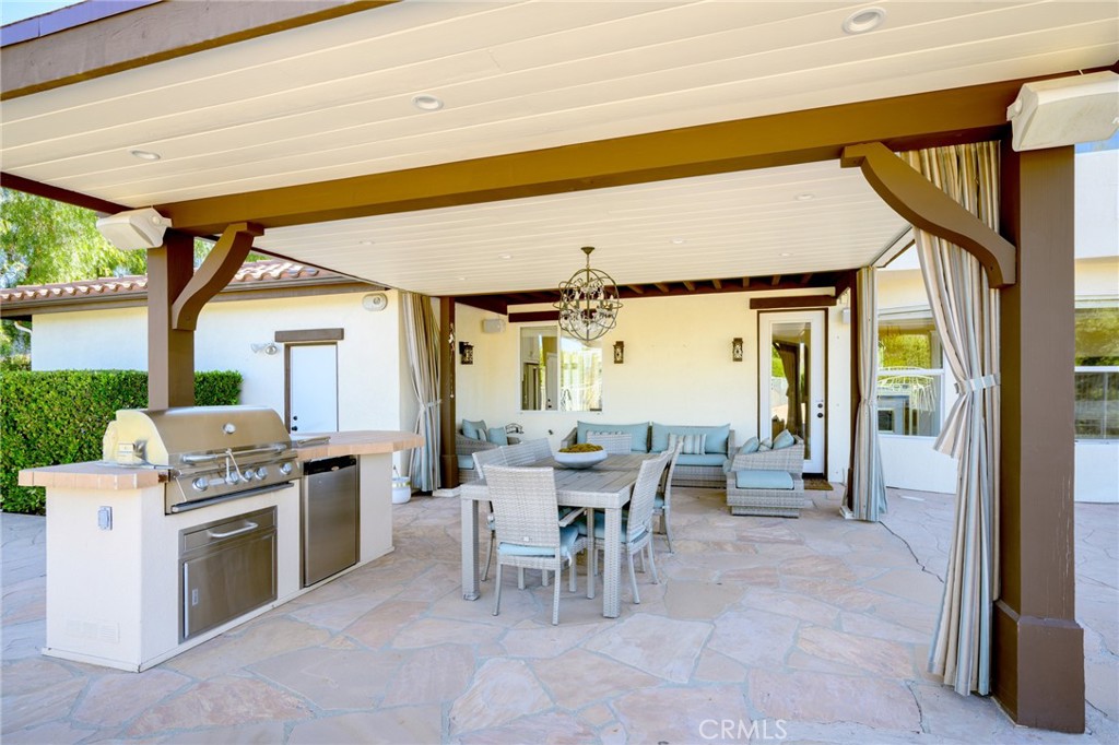 7370 West Chantilly Court Tujunga, CA 91042 - Photo 46 of 55 a dining hall with furniture a window and a fireplace
