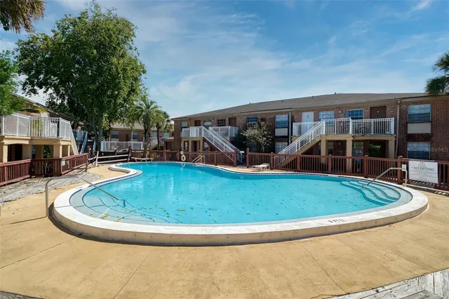 a view of a swimming pool with an outdoor seating