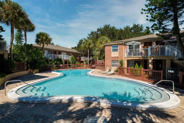 a view of a house with swimming pool and sitting area