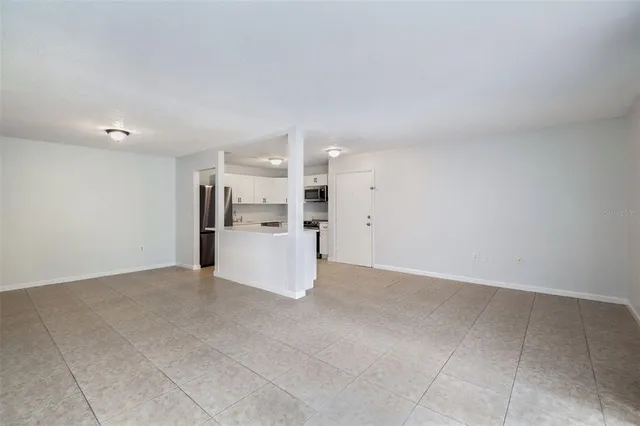 a view of a kitchen with a sink and a refrigerator