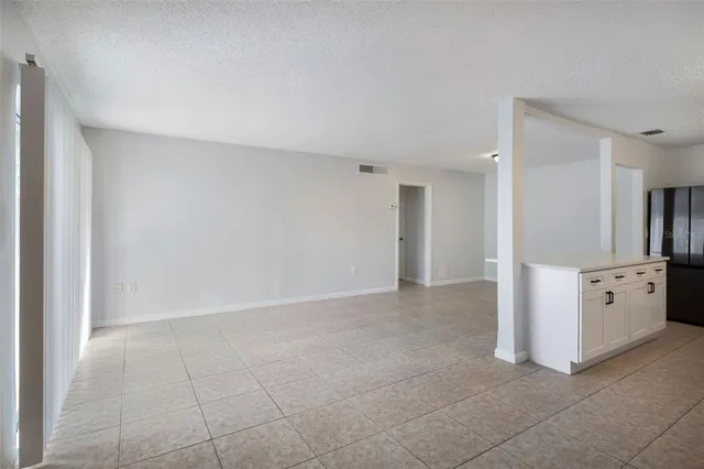 a view of a kitchen with white cabinets