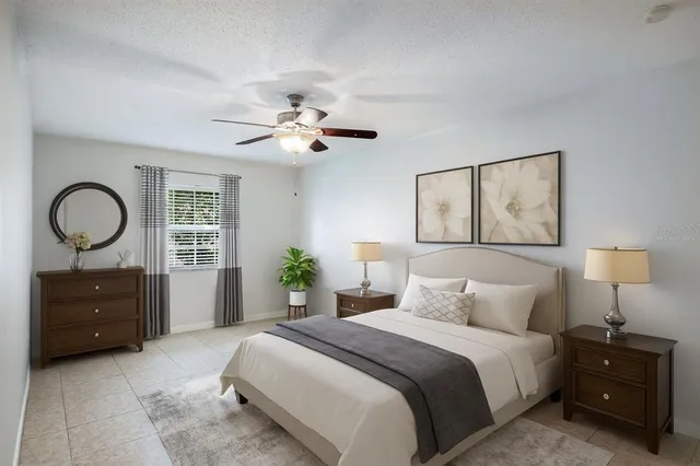 a bedroom with a bed and a painting on the wall