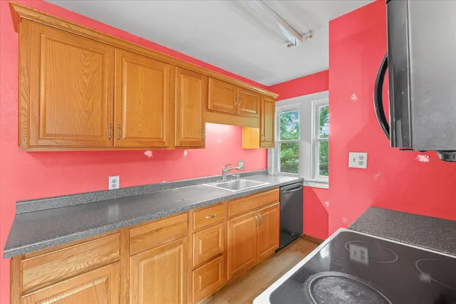 a kitchen with a sink cabinets and a stove