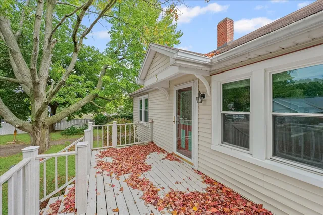 a view of a patio with table and chairs and wooden fence