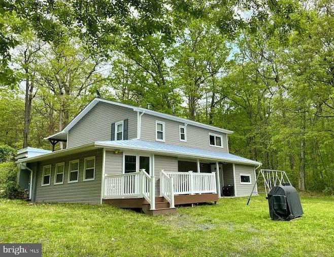 1410 Fleming Park Road Mount Jackson, VA 22842 - Photo 1 of 14 a front view of a house with a yard table and chairs