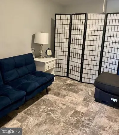 a living room with a couch and a lamp