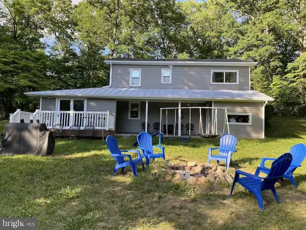 a view of a house with a yard deck and furniture