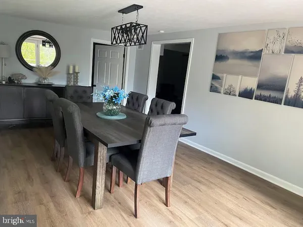 a view of a dining room with furniture and a chandelier