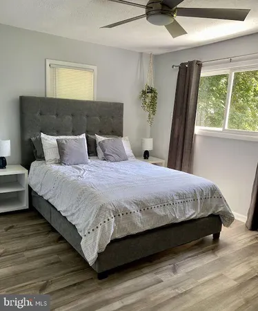 a large bed sitting in a bedroom next to a window