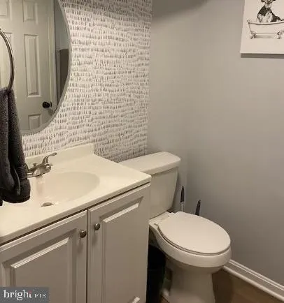 a bathroom with a sink a toilet and mirror