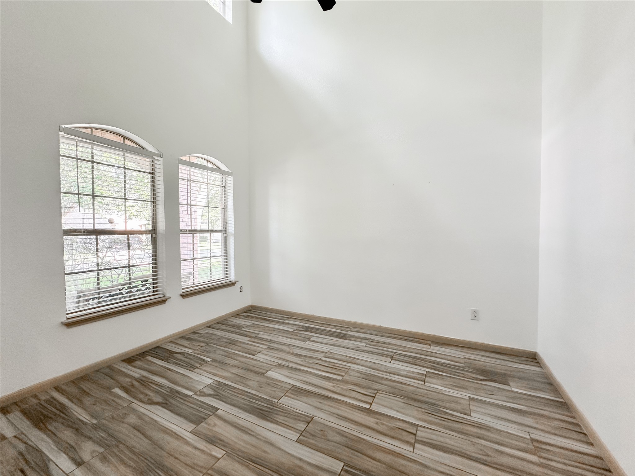 20319 Little Wing Drive Spring, TX 77388 - Photo 8 of 49 an empty room with wooden floor and windows