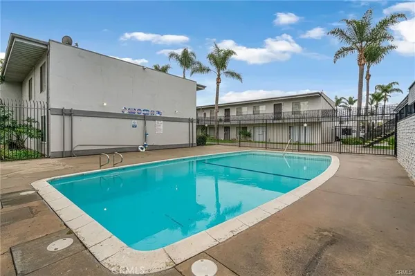 a view of a house with a swimming pool and sitting area
