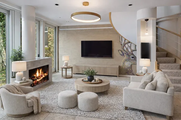 a living room with furniture a fireplace and a flat screen tv