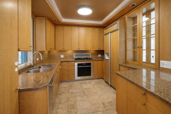 a kitchen with granite countertop a stove and a refrigerator